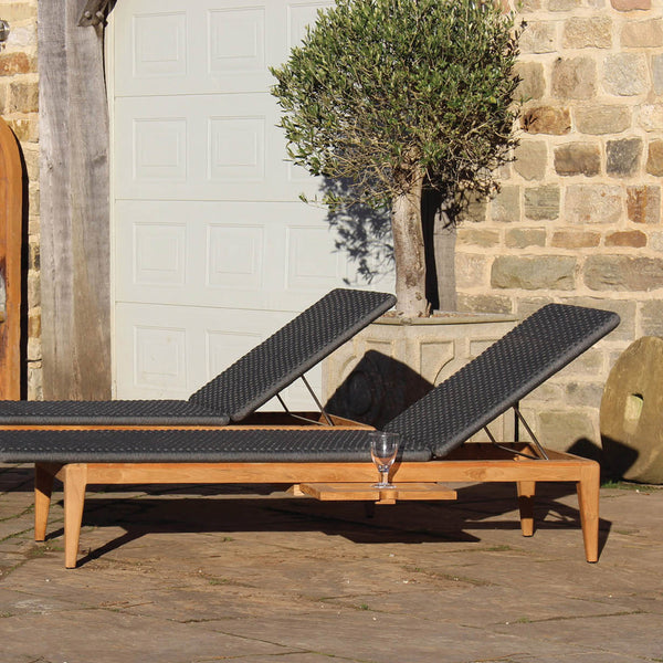 Close up of set of two Gustav teak sun loungers with rope weave